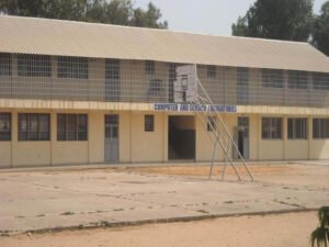 Exterior view and students of Charles Jow Memorial Academy in The Gambia